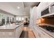 Open-concept living space with a kitchen, island seating, and comfortable living area with ample natural light at 652 Ulster Way, Denver, CO 80230