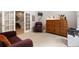 Office space featuring a cozy chair, built-in wooden cabinet, and a neutral carpet at 652 Ulster Way, Denver, CO 80230
