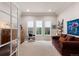 Bright office space featuring a tray ceiling, three windows, and a comfortable sofa at 652 Ulster Way, Denver, CO 80230