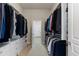 Spacious walk-in closet with built-in shelving and ample hanging space for clothes and storage at 652 Ulster Way, Denver, CO 80230