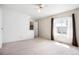 Bedroom with a closet, neutral carpet, a ceiling fan, and a sunny window at 16035 E Ithaca Pl # D, Aurora, CO 80013