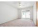 Bright bedroom with a ceiling fan and sliding glass door to the outside at 16035 E Ithaca Pl # D, Aurora, CO 80013