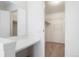 Dressing area with a vanity, and walk-in closet featuring shelving at 16035 E Ithaca Pl # D, Aurora, CO 80013