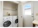 Convenient laundry area featuring a washer, dryer, and outside access at 16035 E Ithaca Pl # D, Aurora, CO 80013