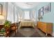 Serene bedroom with bay window, vintage rug, and ample natural light creating a tranquil retreat at 1435 Vine St # 2, Denver, CO 80206