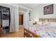Bright bedroom with a closet and drawers for storage featuring a bed with floral comforter at 1435 Vine St # 2, Denver, CO 80206
