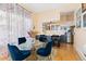 Beautiful dining area open to kitchen has a glass table, hardwood floors, and natural light at 1435 Vine St # 2, Denver, CO 80206