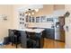 Modern kitchen with white countertops, stainless steel appliances, island seating and ample cabinet space at 1435 Vine St # 2, Denver, CO 80206