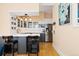 Bright and airy kitchen with white countertops, stainless steel appliances and stylish bar seating at 1435 Vine St # 2, Denver, CO 80206