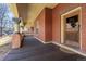 Inviting porch featuring brick columns, a wooden ceiling, and an elegant entrance door at 1435 Vine St # 2, Denver, CO 80206