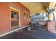 Charming porch area with detailed columns, a rustic wooden door, and a cozy seating arrangement at 1435 Vine St # 2, Denver, CO 80206