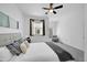 Bright bedroom featuring a ceiling fan, carpeted floor, and comfortable seating area near the window at 2680 Blake St # 13, Denver, CO 80205