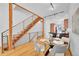 Elegant dining area with a glass table, modern chairs, and a stylish staircase at 2680 Blake St # 13, Denver, CO 80205