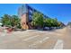 Contemporary condos with a brick base, metal siding, and well-maintained landscaping on a sunny street at 2680 Blake St # 13, Denver, CO 80205