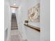 Inviting hallway with a staircase, neutral paint, decor shelf, and modern tiled floors at 2680 Blake St # 13, Denver, CO 80205