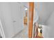 Hallway leading to a bathroom and featuring wood-trimmed stairwell at 2680 Blake St # 13, Denver, CO 80205