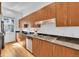 A chef-ready kitchen with stainless appliances, gas range, sleek counters, and rich wood cabinetry at 2680 Blake St # 13, Denver, CO 80205