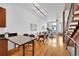 Bright open-concept living room featuring hardwood floors, modern lighting, and a dining area with a staircase at 2680 Blake St # 13, Denver, CO 80205