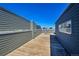 Spacious rooftop deck offering an outdoor living space with wood flooring and blue siding at 2680 Blake St # 13, Denver, CO 80205