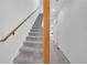 Carpeted staircase with wood accents and white walls leading to the upper level of the home at 2680 Blake St # 13, Denver, CO 80205