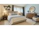 Bright bedroom features a plush bed, large window, stylish dresser, and neutral décor at 5555 E Briarwood Ave # 706, Centennial, CO 80122