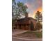 Stunning exterior view of a two-story house with a brick facade and lush green trees at 5555 E Briarwood Ave # 706, Centennial, CO 80122