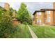 Exterior shot of townhomes featuring well-maintained lawns, walkways, and inviting wooden decks at 5555 E Briarwood Ave # 706, Centennial, CO 80122