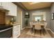 Bright kitchen and dining area with wood floors, white cabinets, and modern appliances at 5555 E Briarwood Ave # 706, Centennial, CO 80122