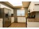 Bright kitchen featuring stainless steel appliances, white cabinetry, and wood flooring at 5555 E Briarwood Ave # 706, Centennial, CO 80122
