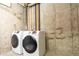 Practical laundry area with side-by-side washer and dryer in a utilitarian space at 5555 E Briarwood Ave # 706, Centennial, CO 80122