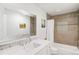 Bright bathroom with a modern vanity, a large mirror, and a shower/tub combination at 10795 E Powers Dr, Englewood, CO 80111