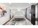 Relaxing bedroom featuring a plush bed, stylish rug, and ample natural light from a bright window at 10795 E Powers Dr, Englewood, CO 80111