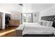 Bright bedroom featuring hardwood floors, arched windows, and closet at 10795 E Powers Dr, Englewood, CO 80111