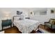 Cozy bedroom with hardwood floors, accent furniture, and a bright window offers a peaceful retreat at 10795 E Powers Dr, Englewood, CO 80111