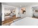 Inviting bedroom with neutral decor leading to a living room and bathroom, creating a cohesive space at 10795 E Powers Dr, Englewood, CO 80111