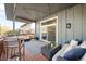Spacious covered deck perfect for entertaining with stylish outdoor furniture and overhead lighting at 10795 E Powers Dr, Englewood, CO 80111