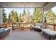 Spacious deck with outdoor seating and views of the wooded backyard at 10795 E Powers Dr, Englewood, CO 80111