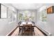 Bright dining room with large windows and a wooden table at 10795 E Powers Dr, Englewood, CO 80111