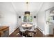 Bright dining room featuring a round table, hardwood floors, and modern light fixture at 10795 E Powers Dr, Englewood, CO 80111