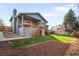 Charming home exterior with a covered deck, well-maintained lawn, and mature trees, perfect for outdoor enjoyment at 10795 E Powers Dr, Englewood, CO 80111