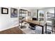 Inviting home office with large arched window, desk, and bookshelf at 10795 E Powers Dr, Englewood, CO 80111