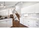 Bright kitchen boasts white cabinets, stainless appliances, and hardwood floors throughout home at 10795 E Powers Dr, Englewood, CO 80111