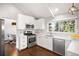 Modern kitchen featuring white cabinets, quartz countertops, and stainless steel appliances at 10795 E Powers Dr, Englewood, CO 80111
