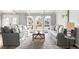 Bright living room with dual sofas, decorative rug, and arched windows offering natural light at 10795 E Powers Dr, Englewood, CO 80111