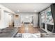 Open-concept living space leading to a bedroom with sliding glass doors and a comfortable seating area at 10795 E Powers Dr, Englewood, CO 80111