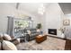 Bright living room with high ceilings, a stone fireplace, and access to the outdoor patio at 10795 E Powers Dr, Englewood, CO 80111