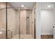 Elegant glass-enclosed shower with tiled walls, integrated shelving, and sleek fixtures for a spa-like feel at 10795 E Powers Dr, Englewood, CO 80111