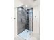 Modern walk in shower with dark tile and glass door at 950 Tenderfoot Dr, Larkspur, CO 80118