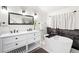 Bathroom with double vanity, soaking tub, and dark tile at 950 Tenderfoot Dr, Larkspur, CO 80118