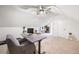 Spacious bonus room with a desk, treadmill and plenty of natural light at 950 Tenderfoot Dr, Larkspur, CO 80118